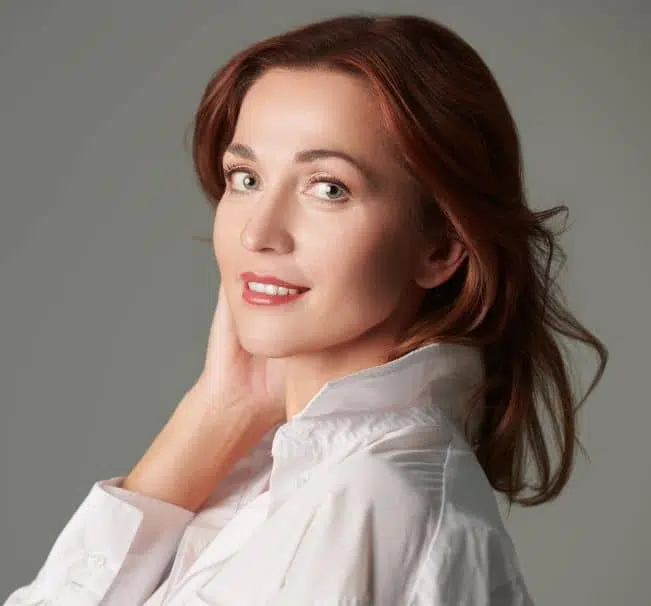 Confident woman with radiant skin symbolizing enhanced results from Ariessence Pure PDGF+ combination treatments.