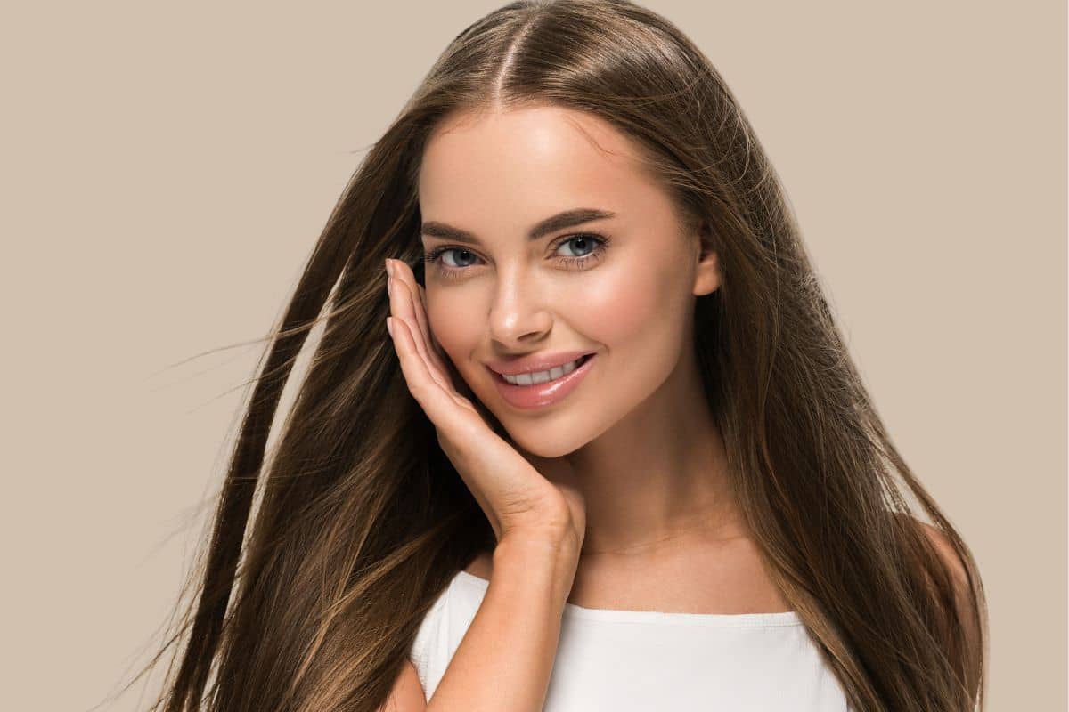 Young woman with radiant skin and shiny hair representing benefits of non-surgical Ariessence PDGF+ therapy.