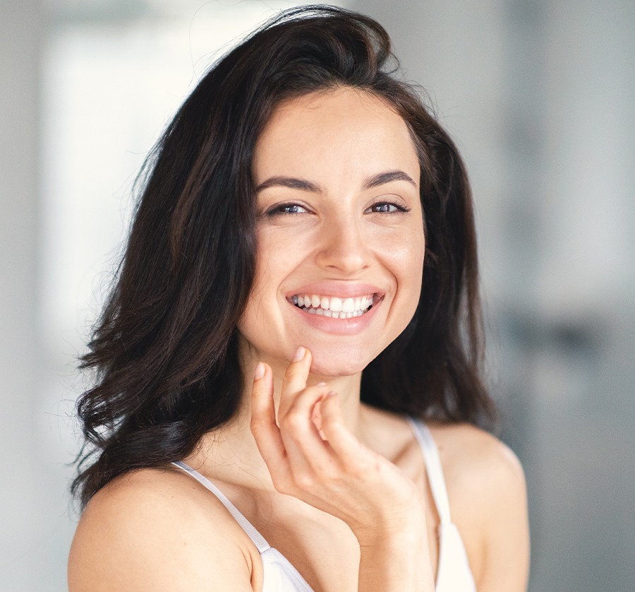 Smiling woman with smooth, radiant skin after Hyperdilute Radiesse treatment to improve tone and elasticity