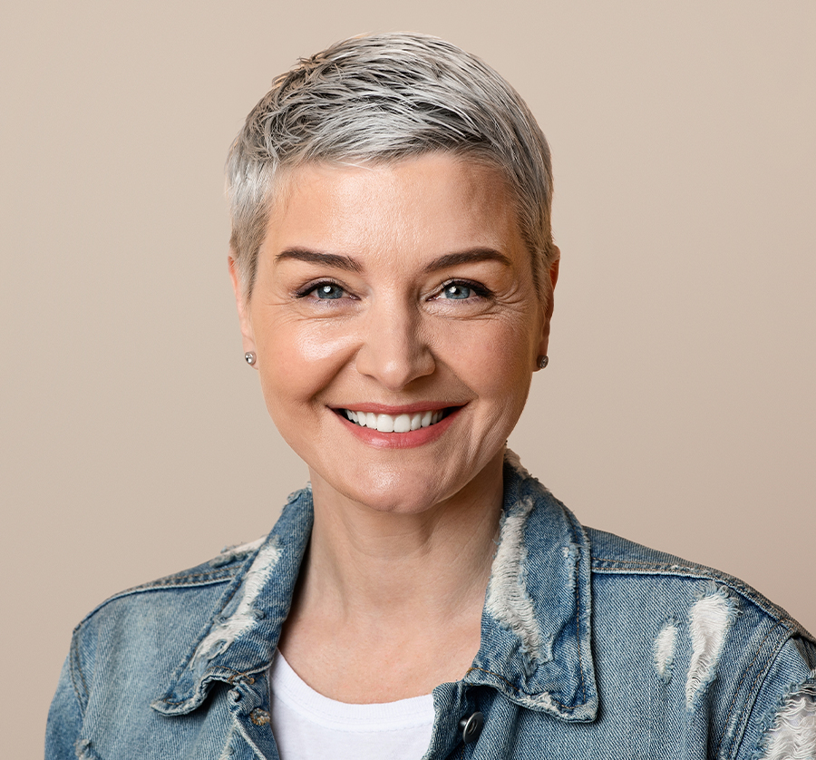 Smiling woman with smooth skin after minimally invasive Hyperdilute Radiesse procedure performed in Newburgh clinic