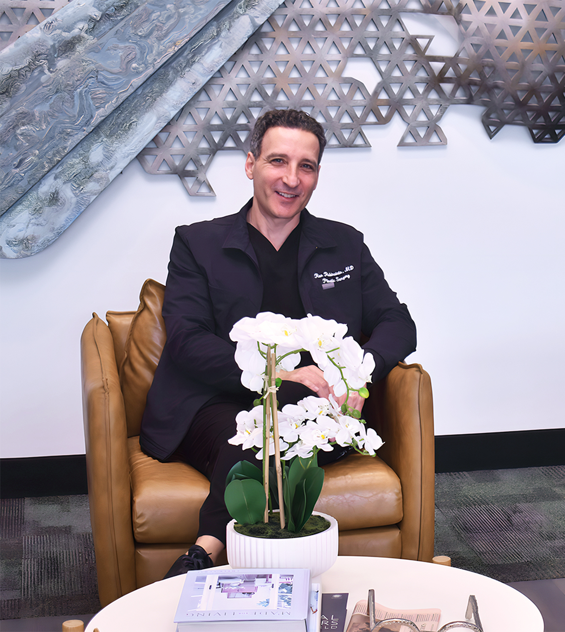 Dr. Ran Rubinstein seated in a modern clinic, representing personalized aesthetic treatments and advanced medical spa care in Newburgh